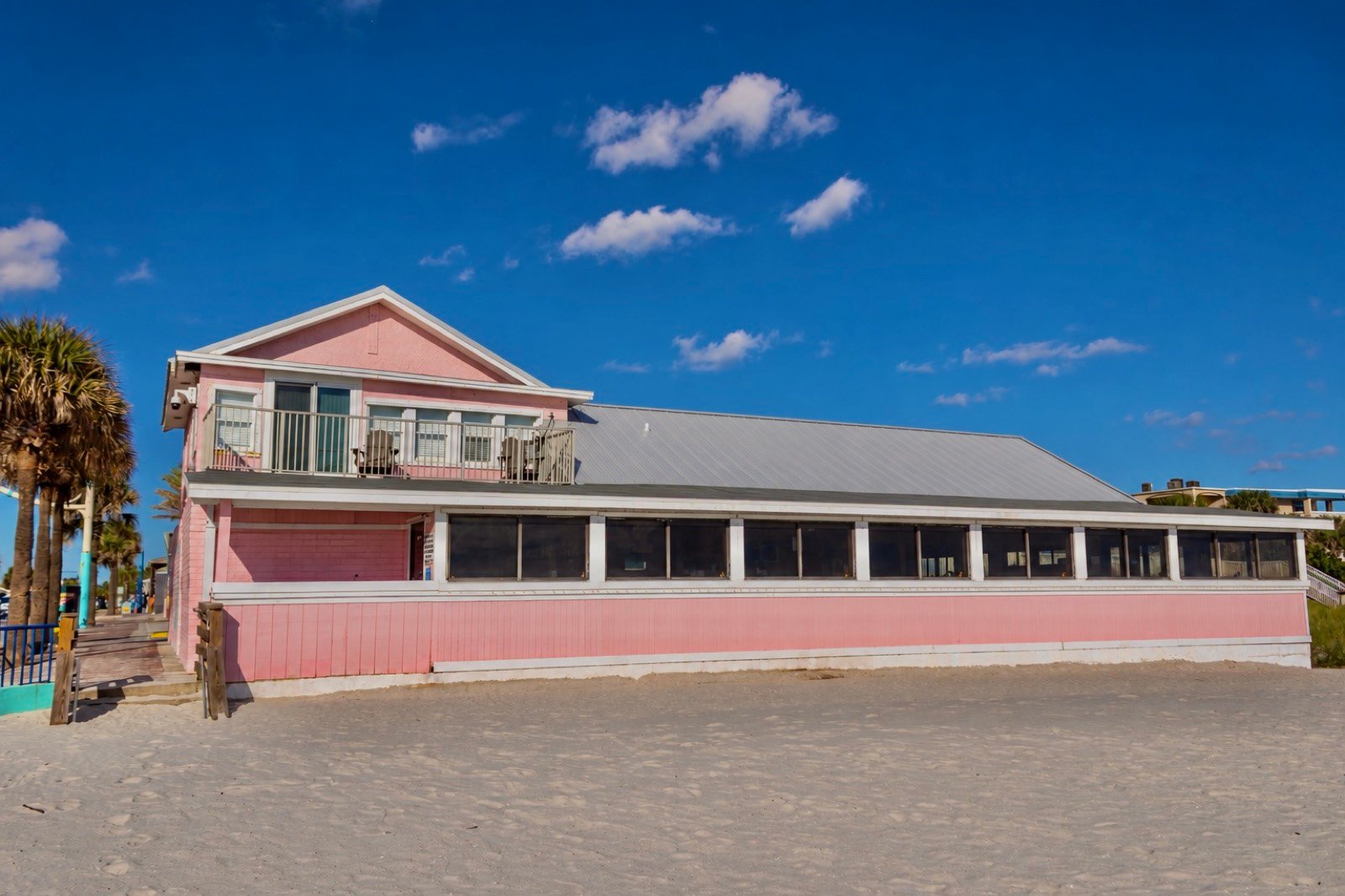 The pink Breakers building viewed from the beach on a clear day